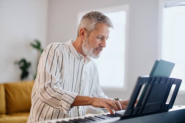 istock Side view of a concentrated man playing piano 2210570020