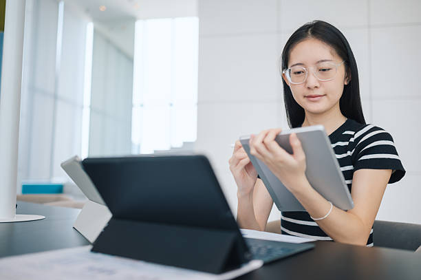 istock Gen z entrepreneur using technology for online business and financial management  working remotely with laptop and smartphone in a modern office 2210570276
