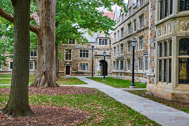 istock Serene University Campus with Historic Building and Lush Trees 2210570680