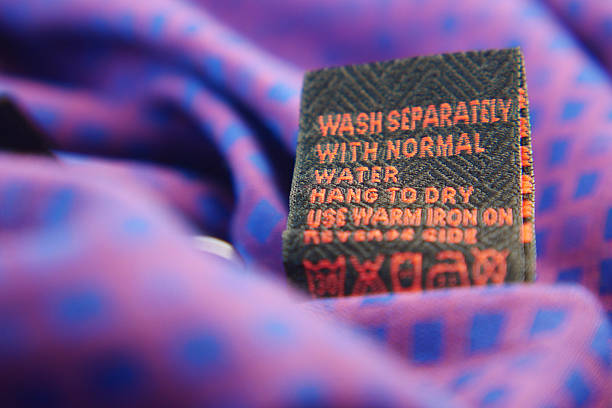 istock Clothing label with care symbols on a cloth 2210570983