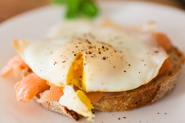 istock Dietary slice of bread with cooked egg and lightly salted red fish 2210572298