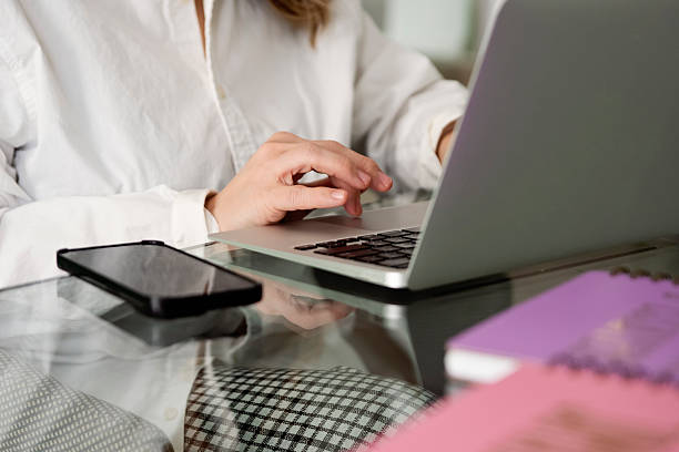 istock Close-up on woman's hand on laptop at her desk. 2210572384