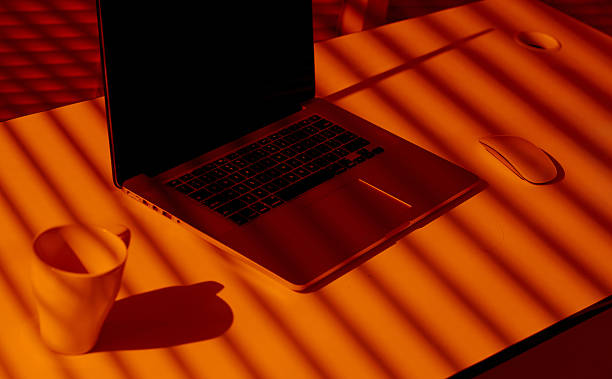 istock Creative Office Setup with Laptop, Mug and Mouse in Sunset Light. 2210573593