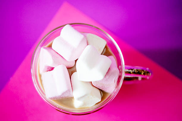 hands of an African girl holding cocoa with a marshmallow, close up