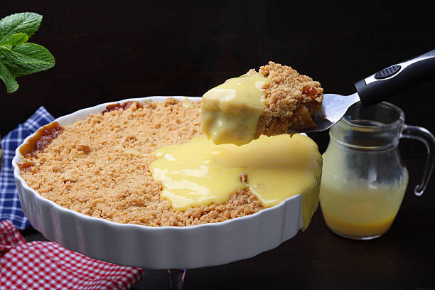 istock Apple Crumble and sweet custard with serving size on spatula 2210575091