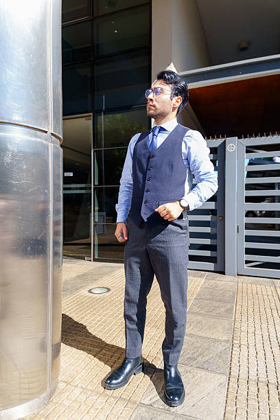 istock Businessman looking up while standing outside office building 2210575140