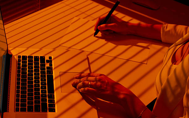 istock Designer Woman Working with Stylus and Laptop at Sunset Desk. 2210575615