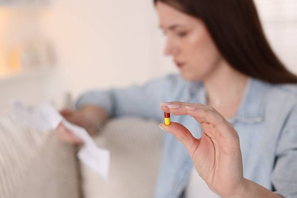istock Woman with pill reading instruction indoors, selective focus 2210578392