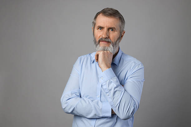 istock Portrait of mature man on grey background 2210579783