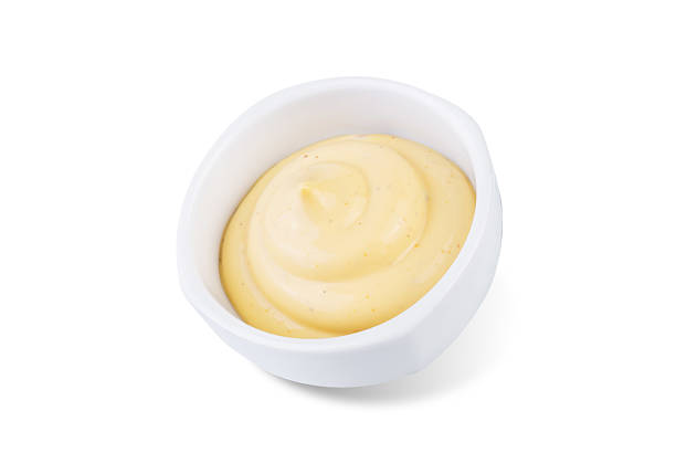 istock Creamy mustard sauce in a bowl on a white isolated background 2210580423