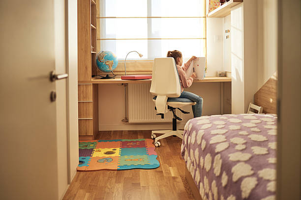 istock Schoolgirl studying at home 2210580913