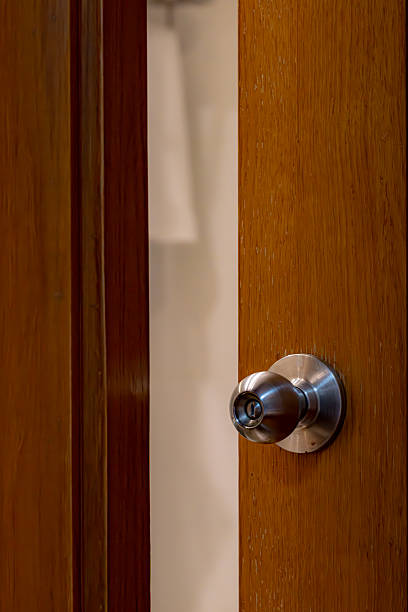 istock A wooden door with a silver knob 2210581002