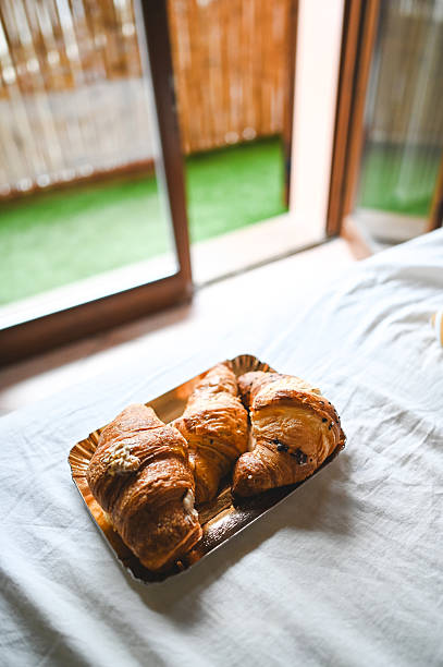 Freshly baked croissants served on a tray, creating a delightful breakfast in bed experience