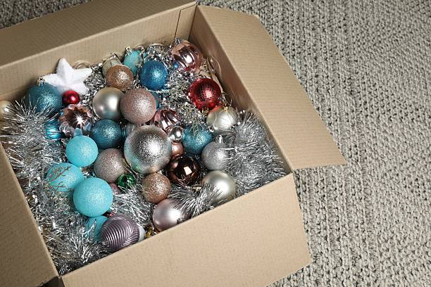 istock Different Christmas decor in cardboard box on carpet indoors 2210581568