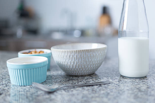 istock Preparing a healthy breakfast with milk and cereal in a modern kitchen 2210582712