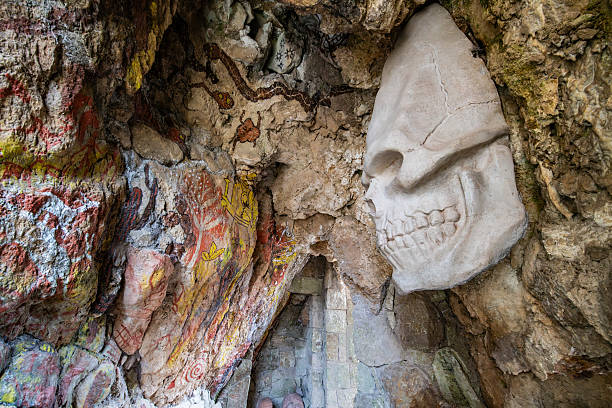 Vadu Crisului Cave in Bihor, Romania, features impressive limestone formations. Stalactites hang from the ceiling, while stalagmites rise from the floor, some meeting to form columns