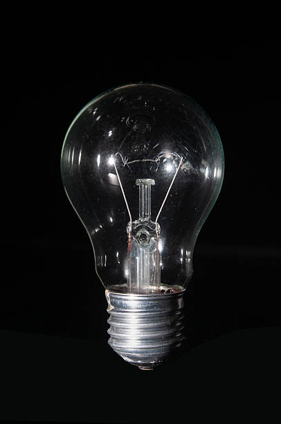 istock Vintage light bulb close up on a black background 2210584338