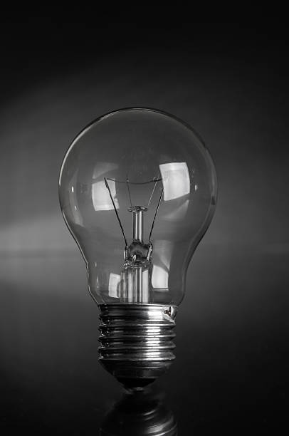 istock Vintage light bulb close up on a black background 2210584350