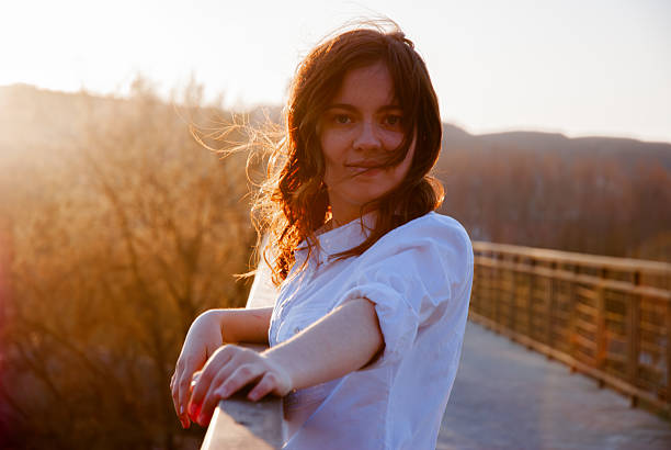 A portrait of a beautiful woman at sunset in the park.