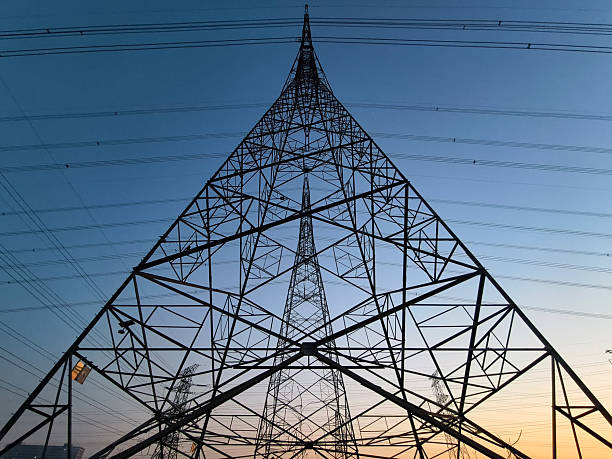 istock Low angle view of electricity pylon against sky during sunset 2210586085