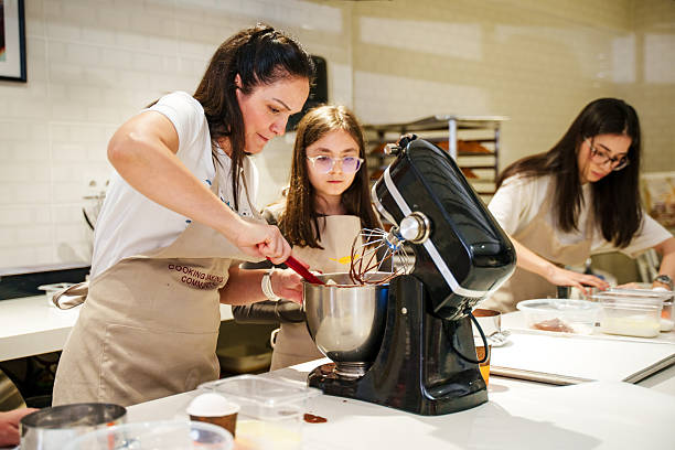 A Mum and daughter are  Decorating Cakes in a Modern Kitchen – Baking Class or Workshop