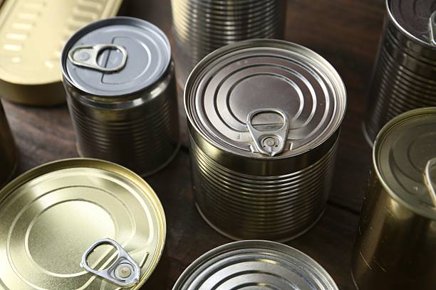 istock Many closed tin cans on wooden table, closeup 2210588345