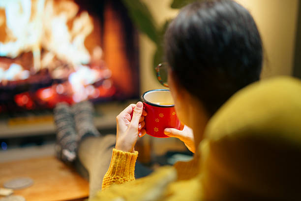 istock Relaxing Winter Evening at Home with a Hot Drink by the Fireplace 2210588365