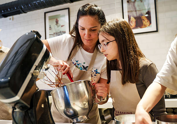 A Mum and daughter are  Decorating Cakes in a Modern Kitchen – Baking Class or Workshop