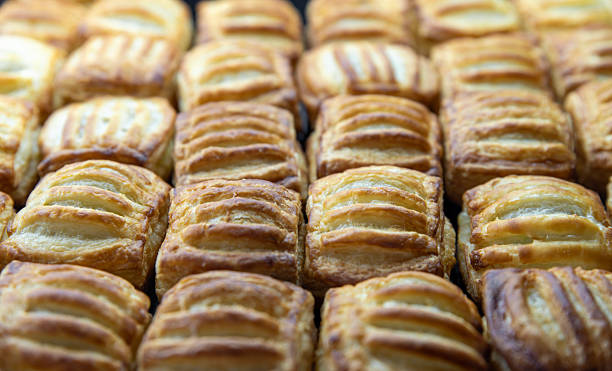istock Rows of flaky puff pastries on a tray 2210591634