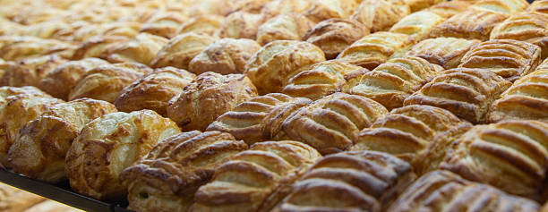 istock Puff pastries arranged in even rows, close-up 2210591636