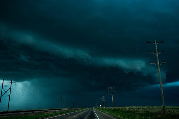 Here comes the rain! Driving down a west Texas highway under heavy, dark,  dramatic storm clouds on a summer evening
