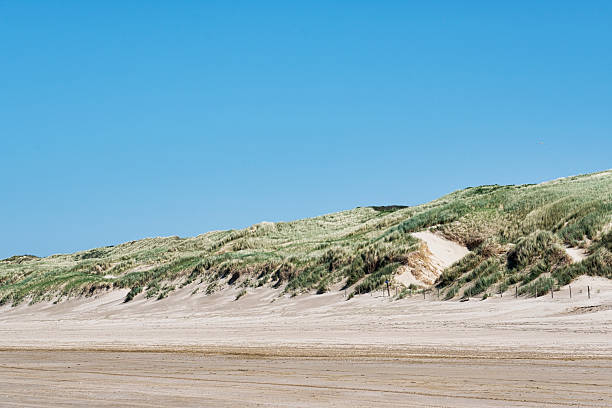 Sand dune in Helgoland under blue sky with clouds, Schleswig-Holstein, Germany