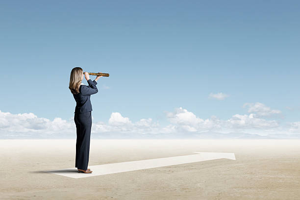 istock Woman Looking Through Spyglass Toward Horizon 2210593271