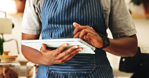 istock Man, hands and waiter with tablet in cafe for planning menu, online order and schedule in startup. Technology, small business and barista in coffee shop for stock, check inventory and communication 2210593809