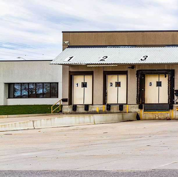 istock Industrial Loading Dock With Numbered Bays and Corrugated Roof Cover 2210594438