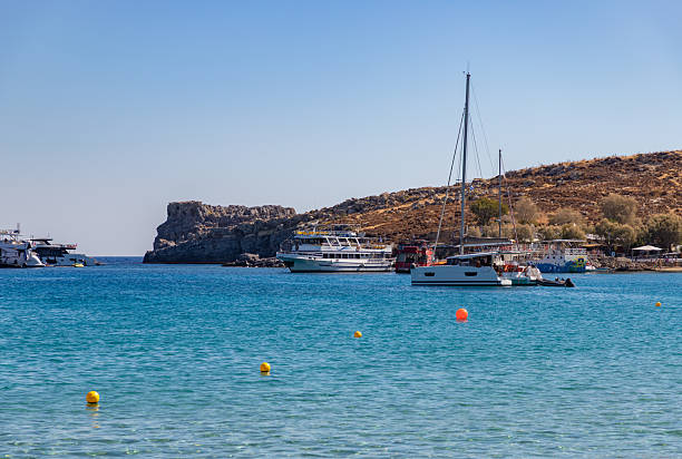 Lindos, Rhodes, Greece - October 21, 2024: A picture of multiple boats at Lindos Beach.