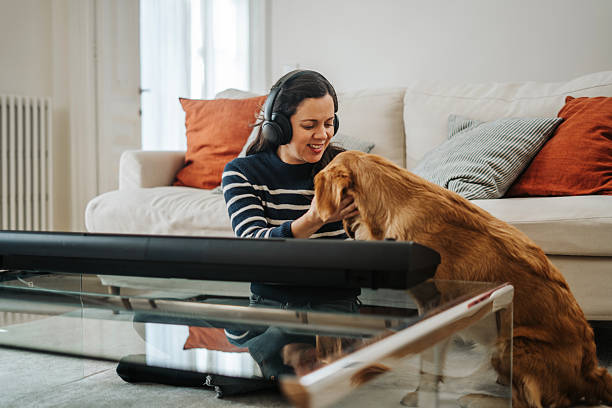 istock Woman playing synthesizer at home 2210598367