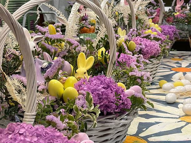 on a large table are large Easter baskets with flowers and bunnies for Easter gifts