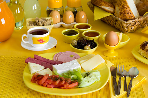 Traditional Turkish Breakfast with fresh orange juice and tea on the yellow background.Used yellow color breakfast set