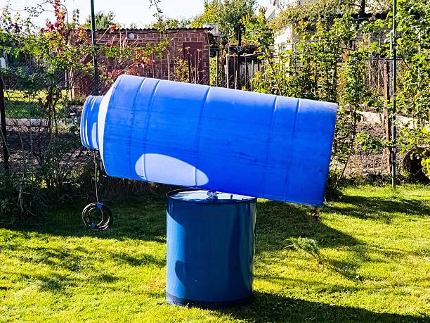 istock Cleaning of a drinking water container. Blue plastic container for clean water is drying in the sun. 2210602344