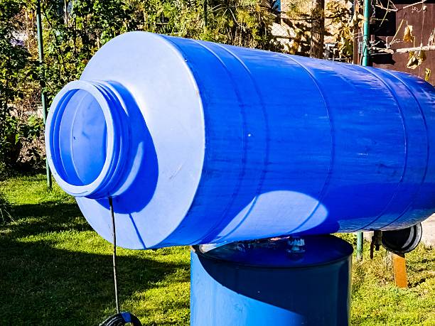 istock Cleaning of drinking water container. A blue plastic container for clean water is drying in the sun. 2210602362