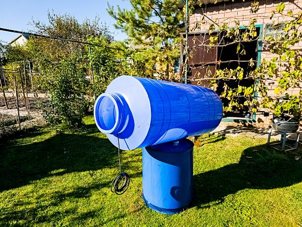 istock Cleaning of a drinking water container. A blue plastic container for clean water is drying in the sun. 2210602363