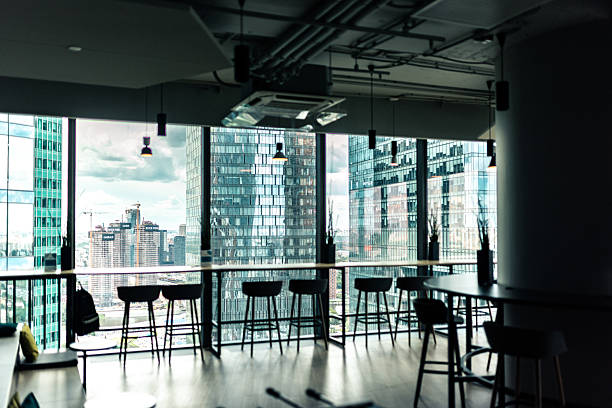 istock Modern office interior overlooking city skyscrapers through large glass windows 2210606737