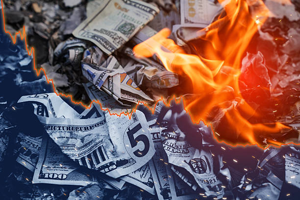 istock Burning US dollar bills with Falling Graph Line Depicting Economic Collapse and Financial Crisis 2210607647