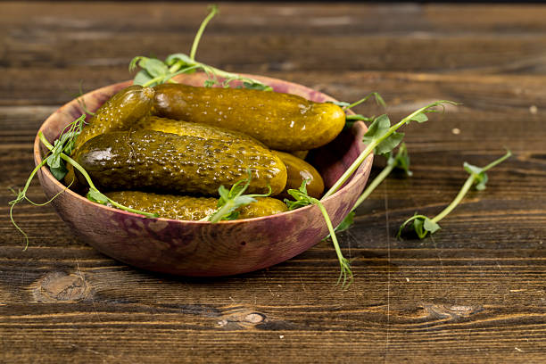 istock ripe cucumbers marinated with salt and spices, pickled cucumbers during cooking 2210609971