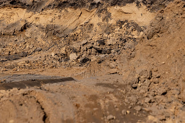 istock construction work during the excavation of a pit for laying different layers of materials before asphalting, a deep hole in the ground 2210610108