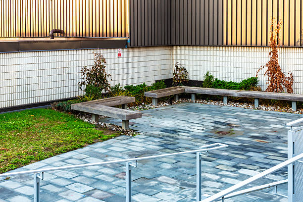 istock Modern Outdoor Courtyard with Benches and Decorative Landscaping 2210614009