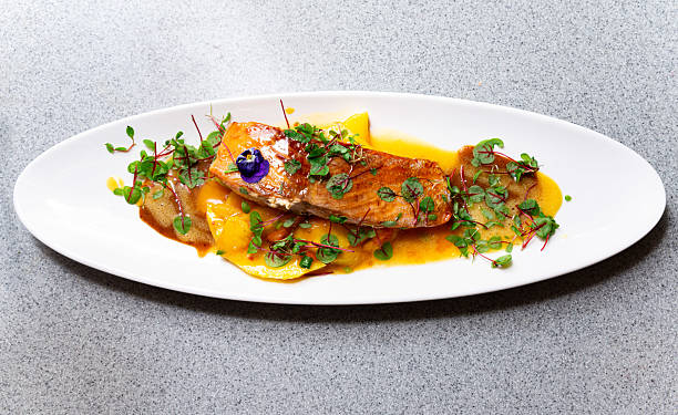 istock Salmon filet with mango puree and herbs. 2210615907