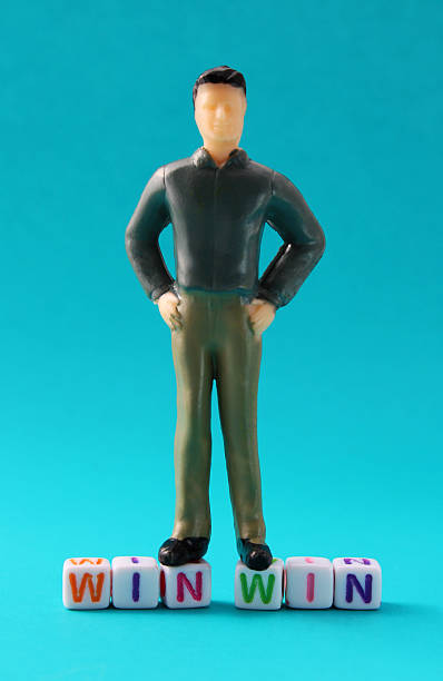 istock Business executive standing on the phrase WIN WIN 2210616119