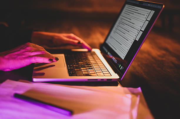 istock Woman working from home at night, using her laptop trackpad 2210620538